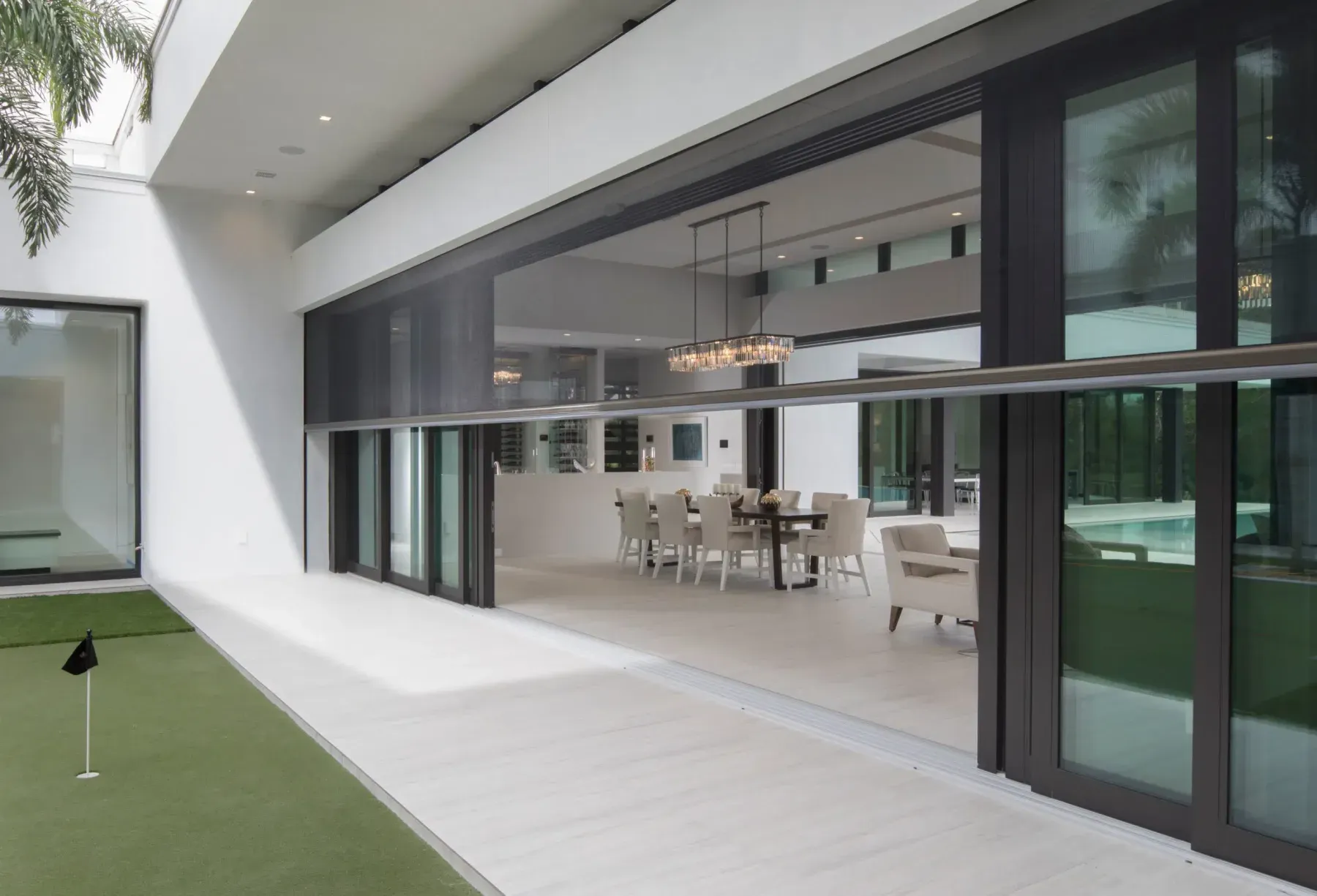Outdoor mesh screen between a living area and the deck