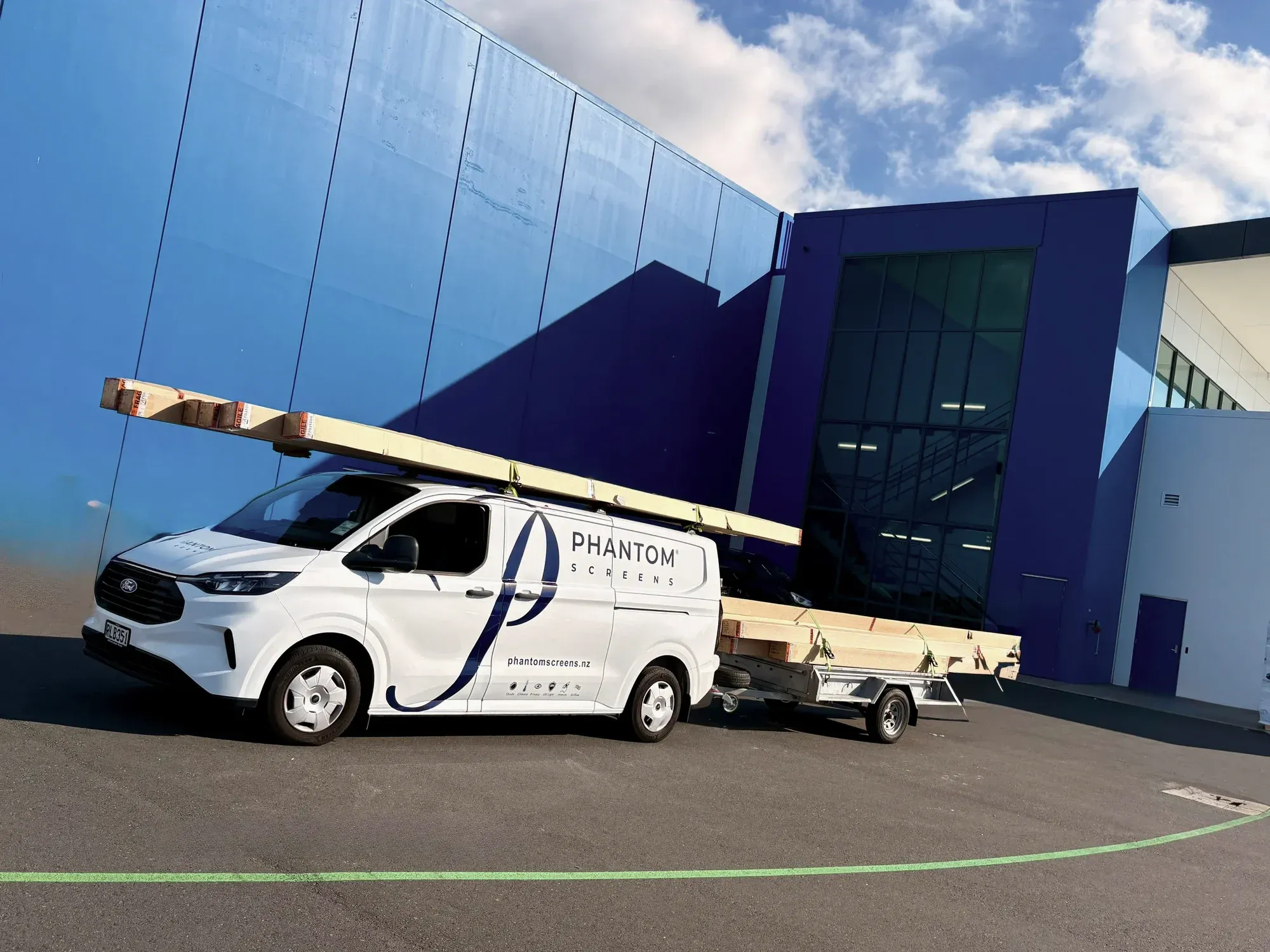 A Phantom Screens work van and trailer loaded with material, out on the road for an install