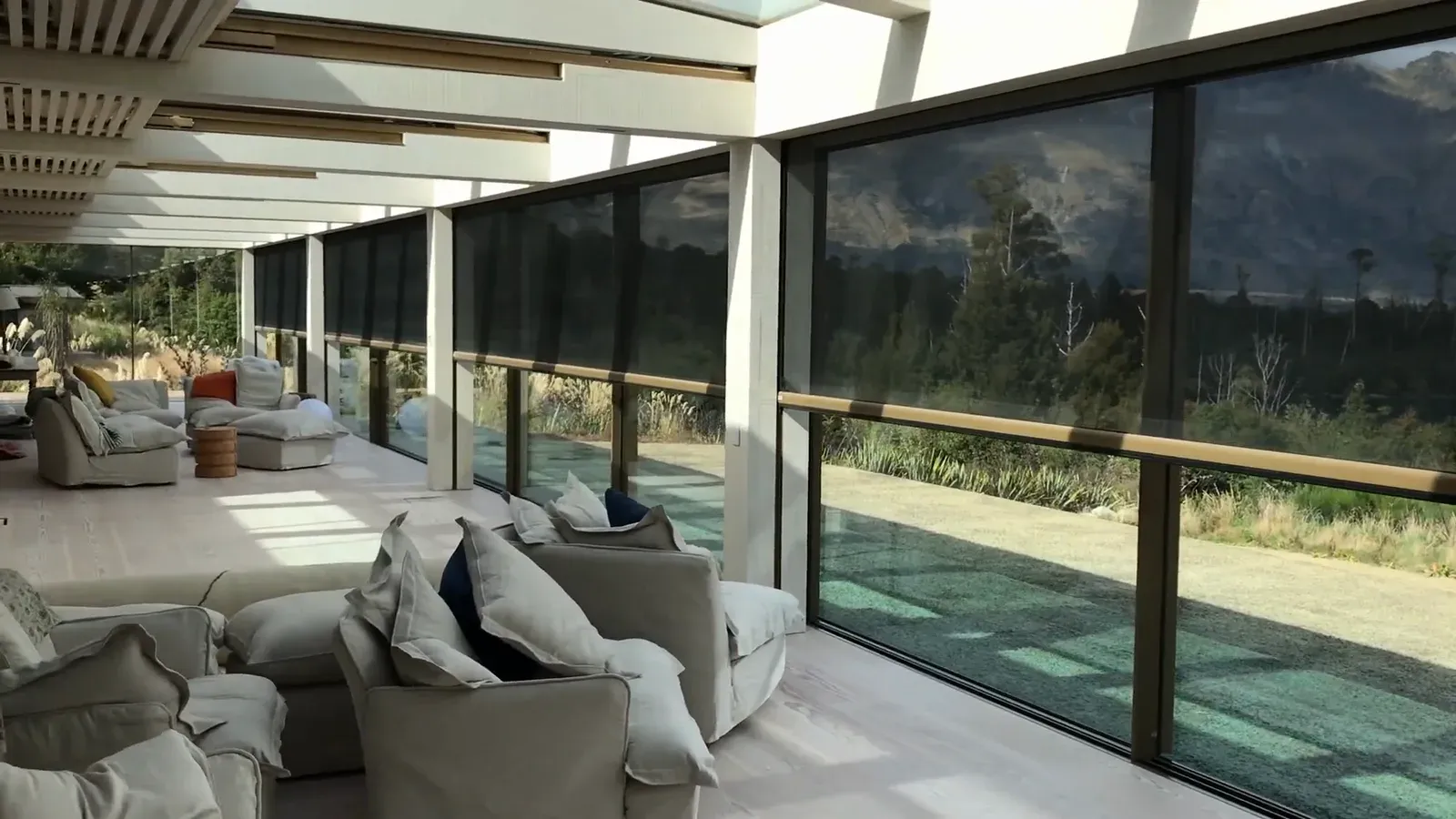 Recessed black Executive screens lowered along a Queenstown veranda, with the mountain range beyond